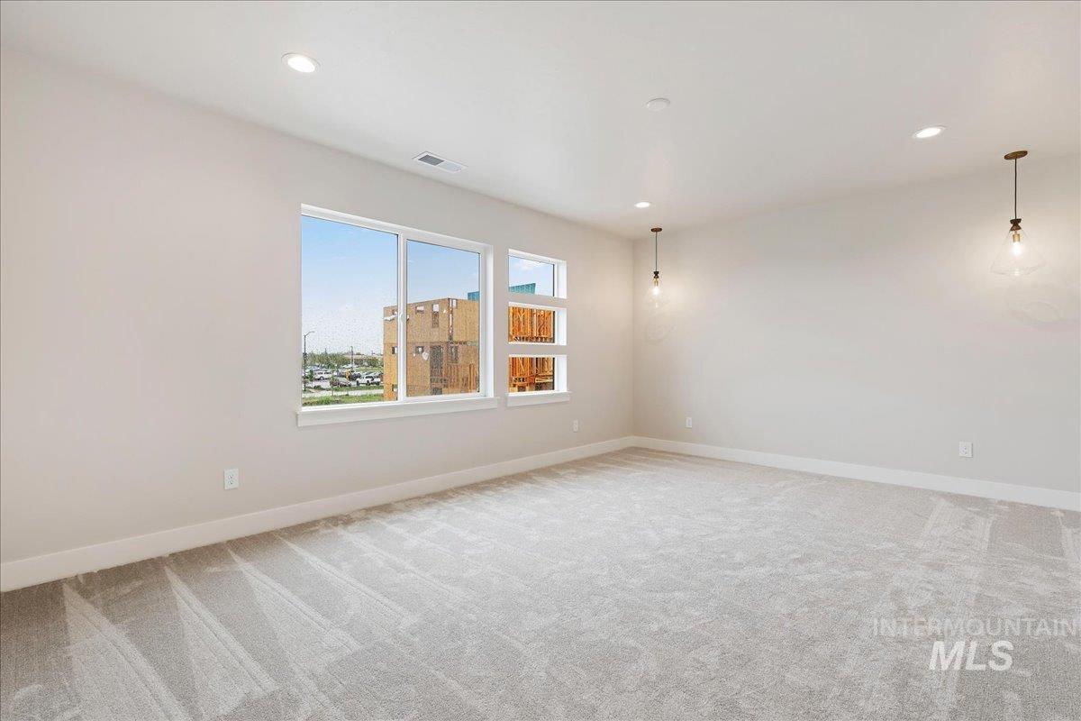 1297 West Malbar Street Meridian, ID 83646 - Photo 19 of 34 Spacious room featuring light gray carpet, white baseboards, and neutral wall tones