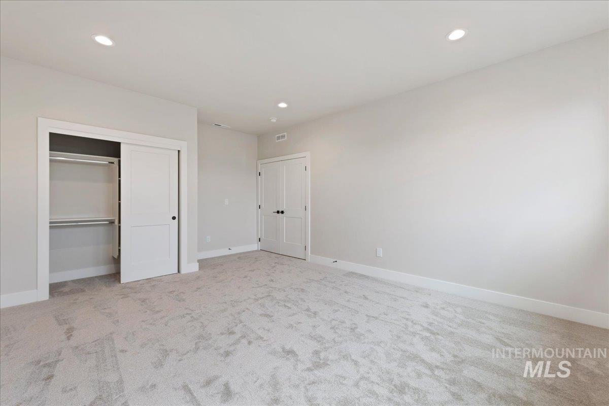 1297 West Malbar Street Meridian, ID 83646 - Photo 29 of 34 Spacious room with light gray walls and plush carpeting