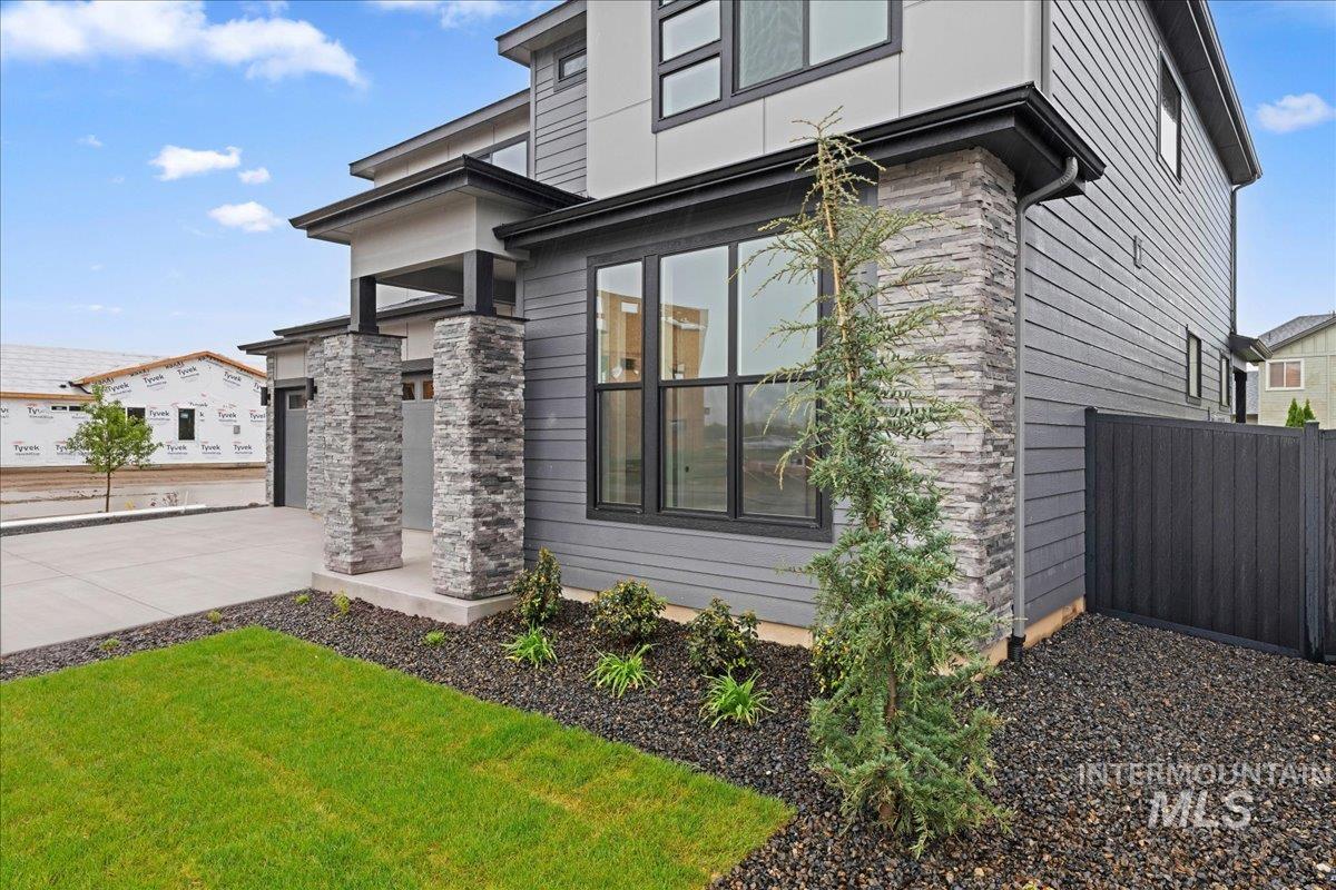 1297 West Malbar Street Meridian, ID 83646 - Photo 3 of 34 Contemporary home exterior featuring a multi-textured facade with horizontal siding and stacked stone accents