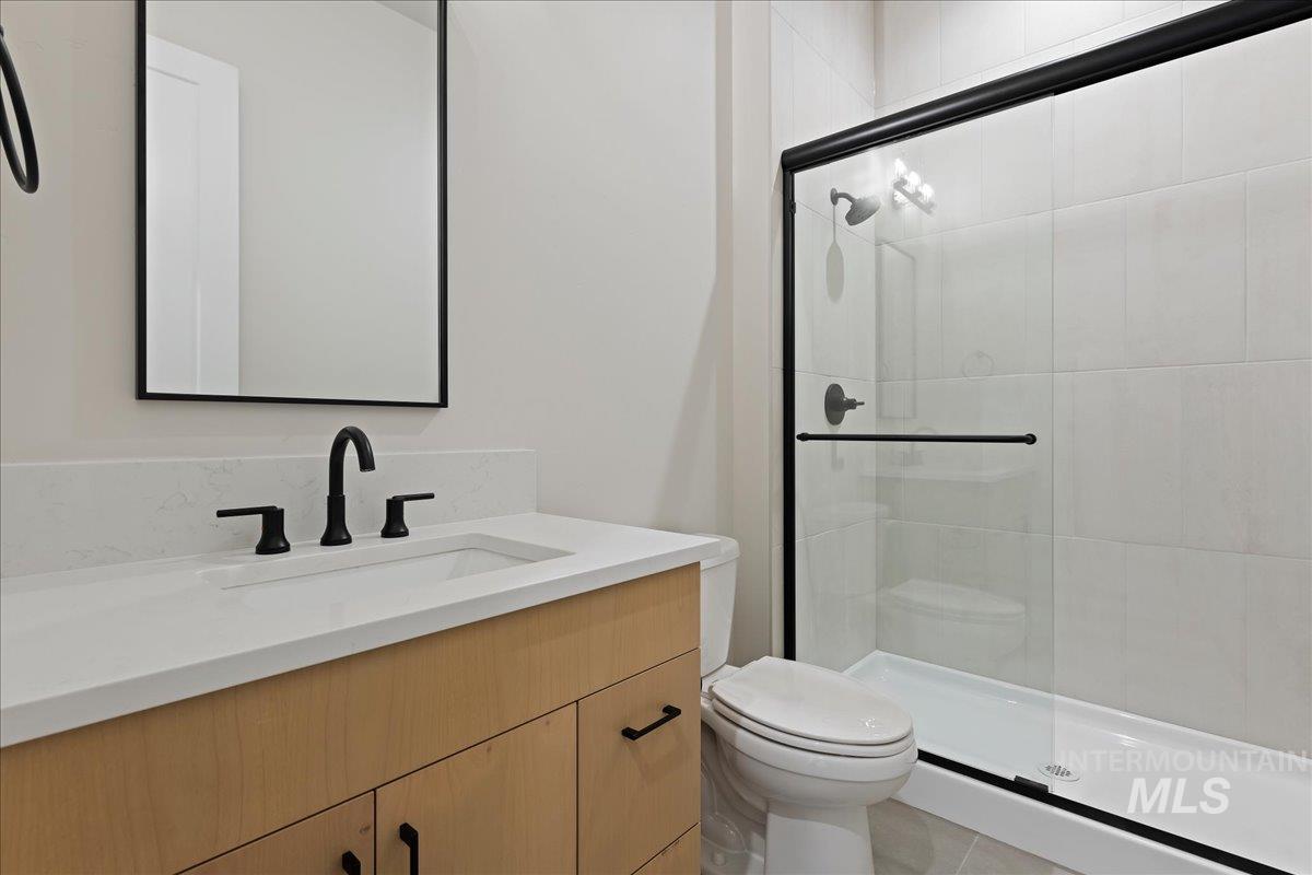1297 West Malbar Street Meridian, ID 83646 - Photo 31 of 34 Bathroom featuring a light wood-finish vanity with a white countertop and integrated sink
