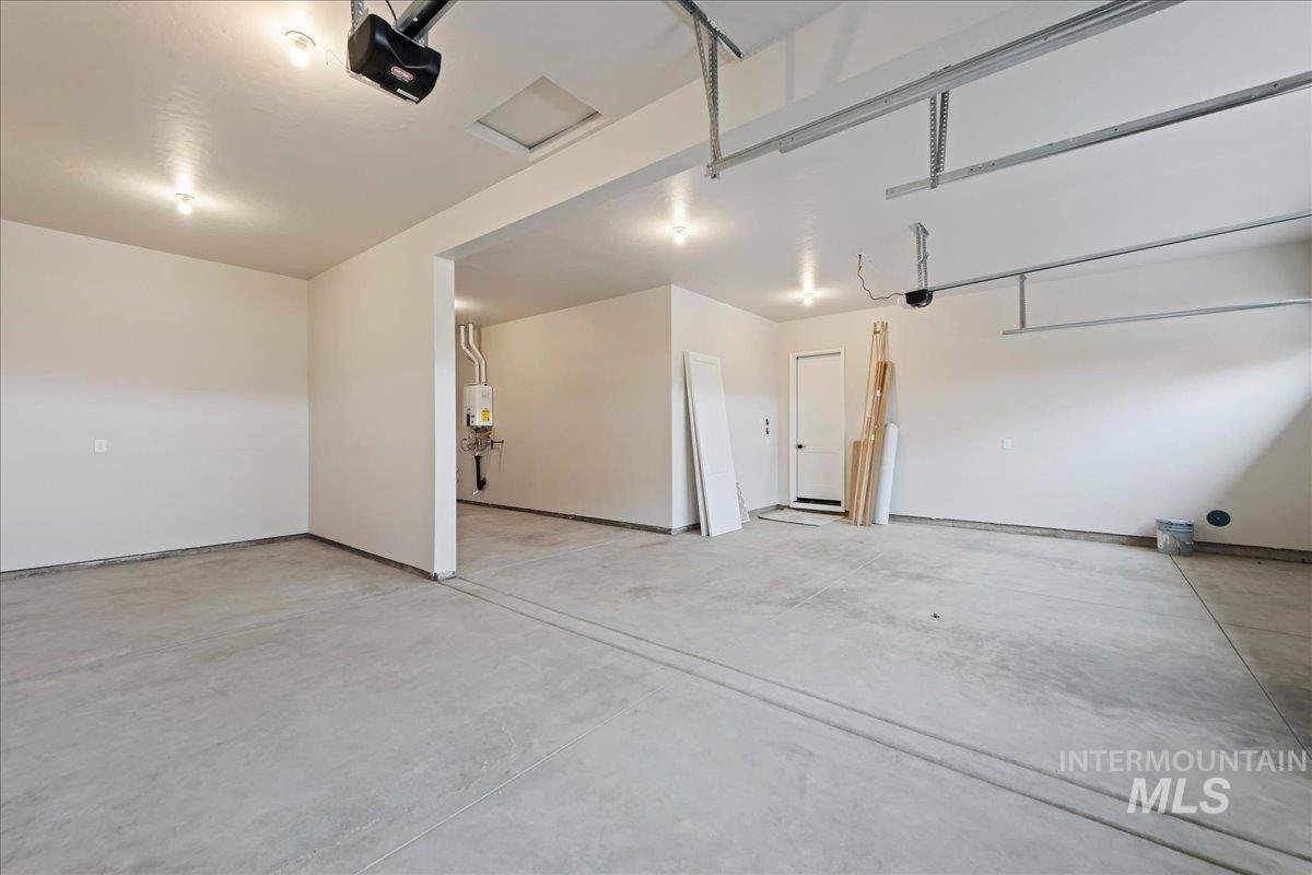 1297 West Malbar Street Meridian, ID 83646 - Photo 33 of 34 Spacious garage featuring a concrete floor, overhead garage door mechanisms, and recessed lighting