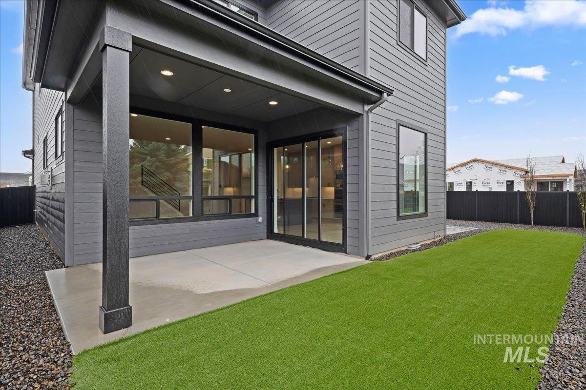 1297 West Malbar Street Meridian, ID 83646 - Photo 34 of 34 Covered concrete patio with recessed lighting, large format windows, a sliding glass door, and a manicured artificial turf lawn