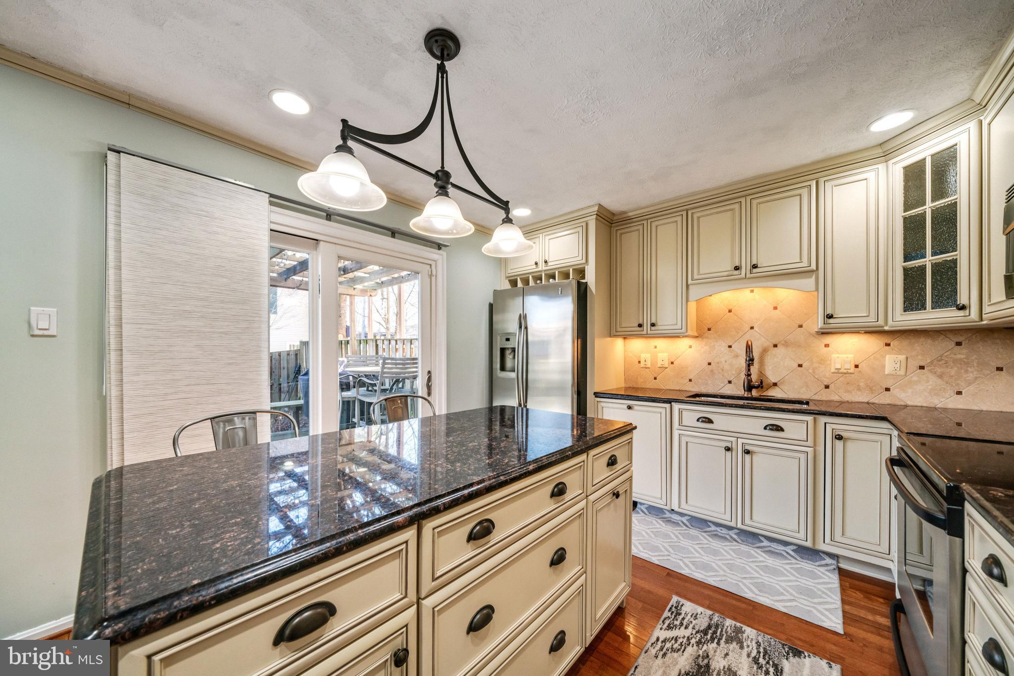 7251 Kousa Lane Springfield, VA 22152 - Photo 9 of 31 Large granite island with doors to fenced backyard