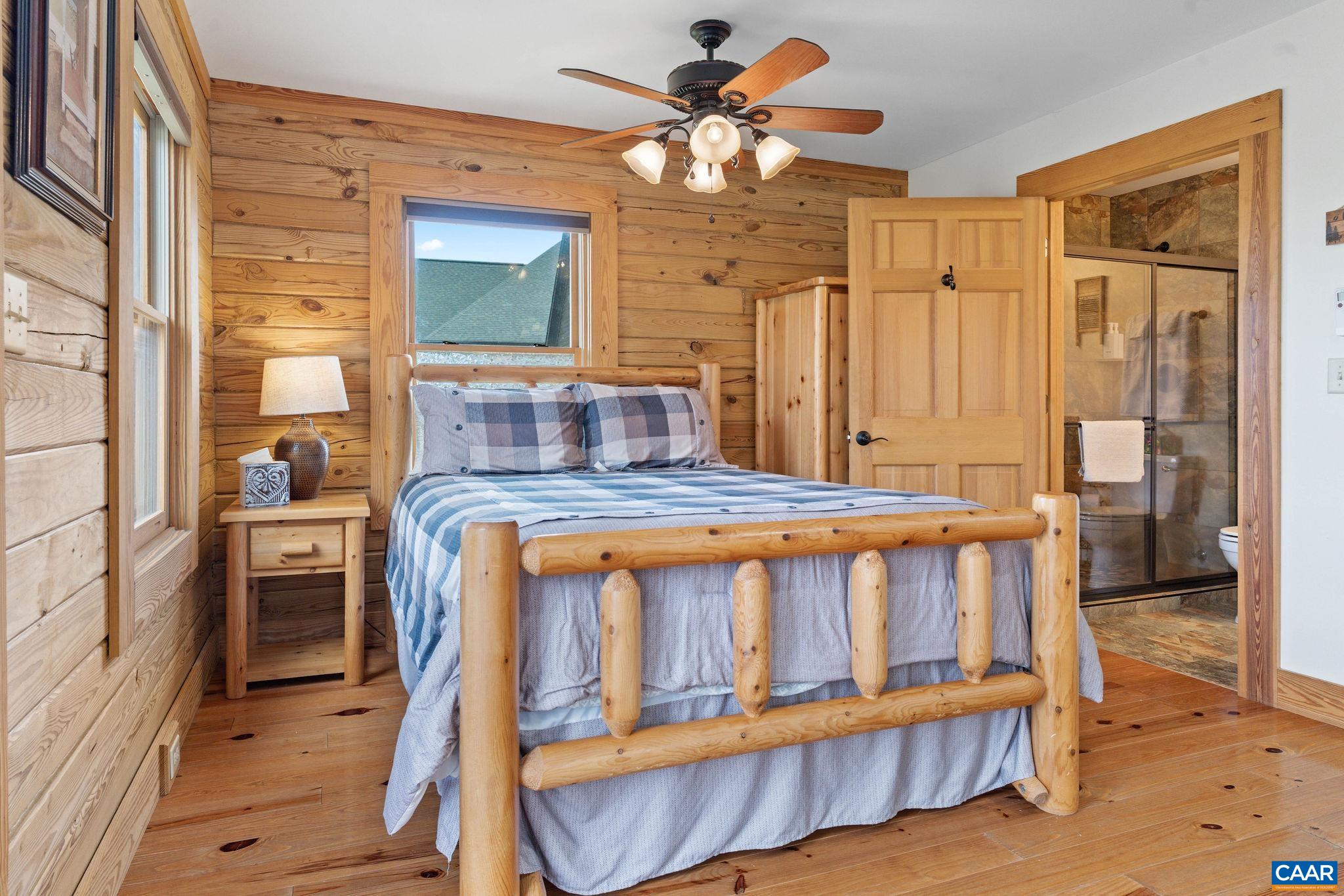 42 River Ridge Lane Stanardsville, VA 22973 - Photo 57 of 70 a view of a bedroom with furniture window and a chandelier