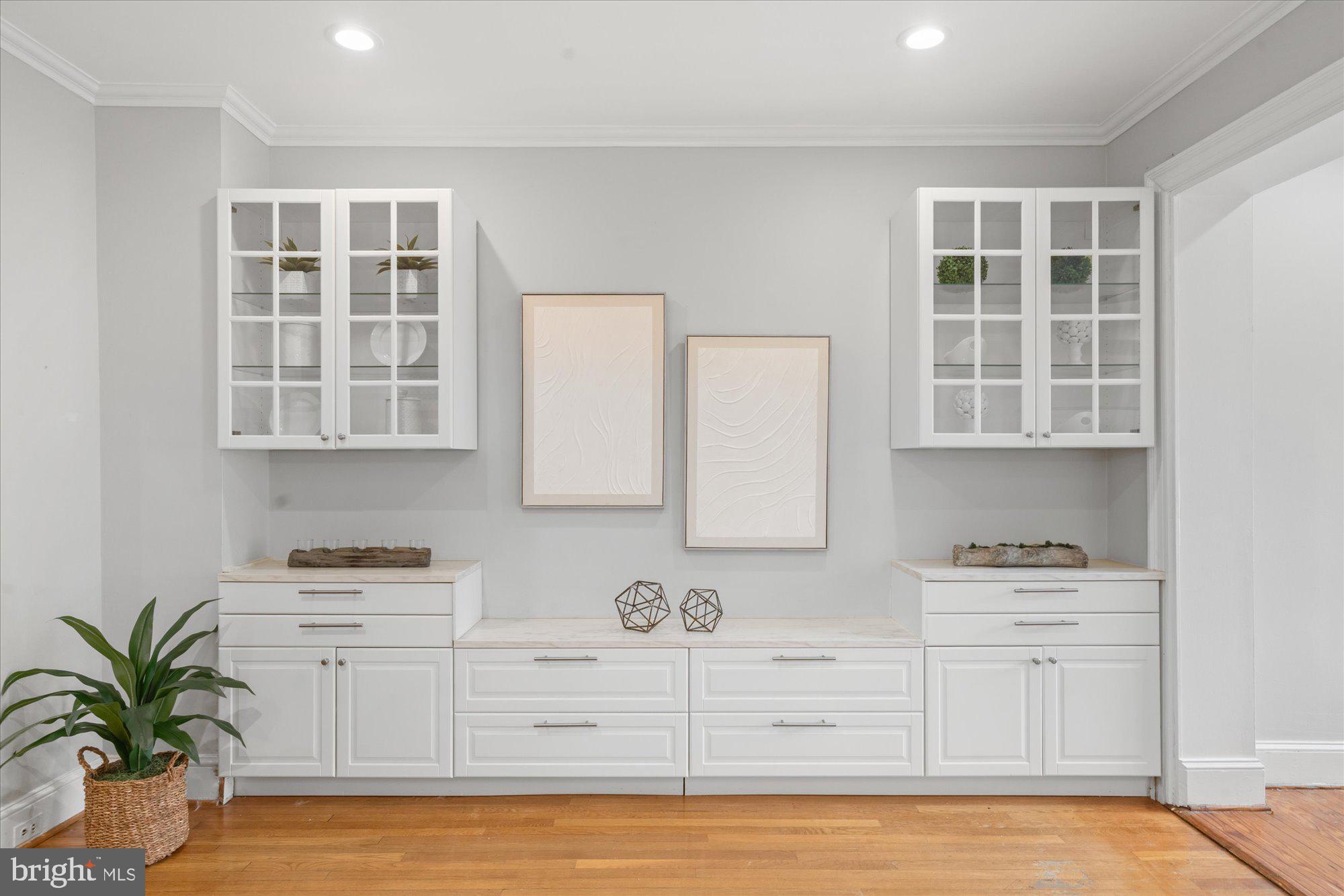 2305 38th Street Northwest Washington, DC 20007 - Photo 14 of 38 a kitchen with a white cabinets and wooden floor