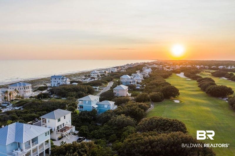 815 Plantation Road, Unit 405 Gulf Shores, AL 36542 - Photo 38 of 39 Aerial view at dusk featuring a water view