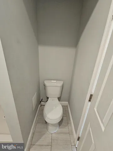 a white toilet sitting next to a small sink