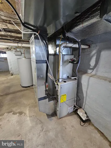a view of a storage room with water heater and racks