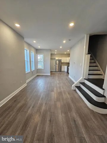 a view of a room with wooden floors and stairs