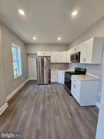 a kitchen with refrigerator and cabinets