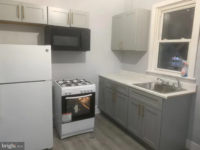 a kitchen with a sink and a refrigerator
