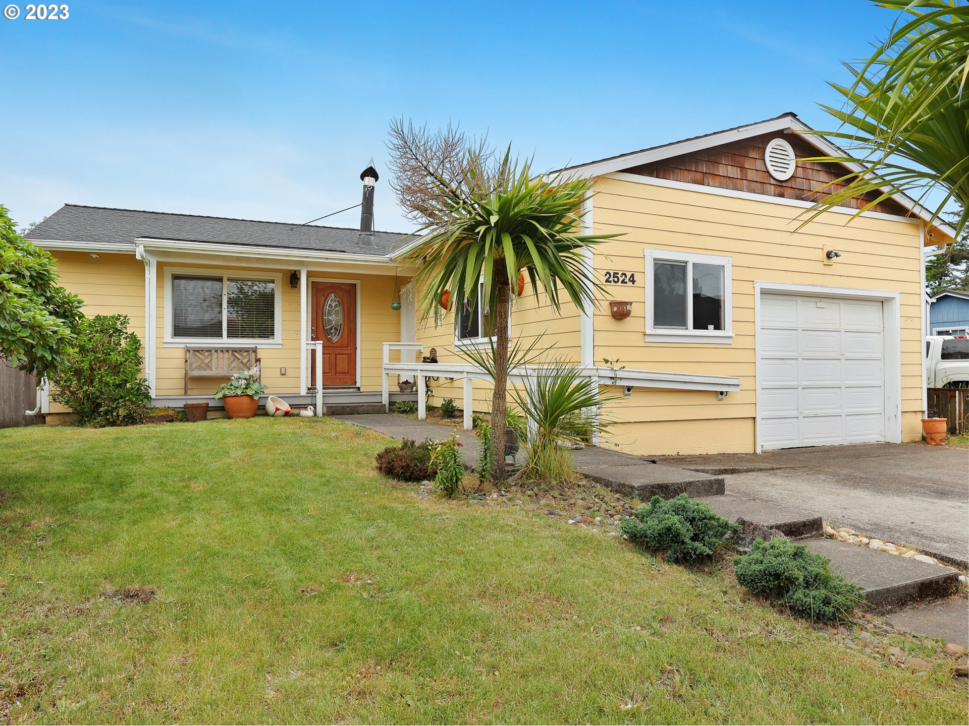 a front view of house with yard and seating space