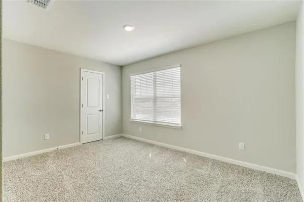 an empty room with a empty space and windows