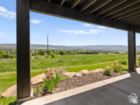 514 North Olympic Way Midway, UT 84049 - Photo 24 of 30 Covered patio featuring a concrete surface, dark wood-finish ceiling, and support columns