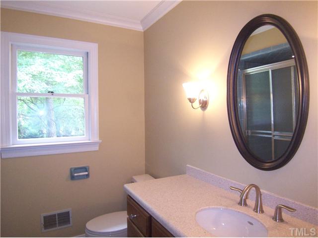 6905 Brook Ridge Court Raleigh, NC 27615 - Photo 13 of 25 View of the 1st floor full tiled Bath w/new cherry vanity, solid surface ctr & brushed nickel faucet.