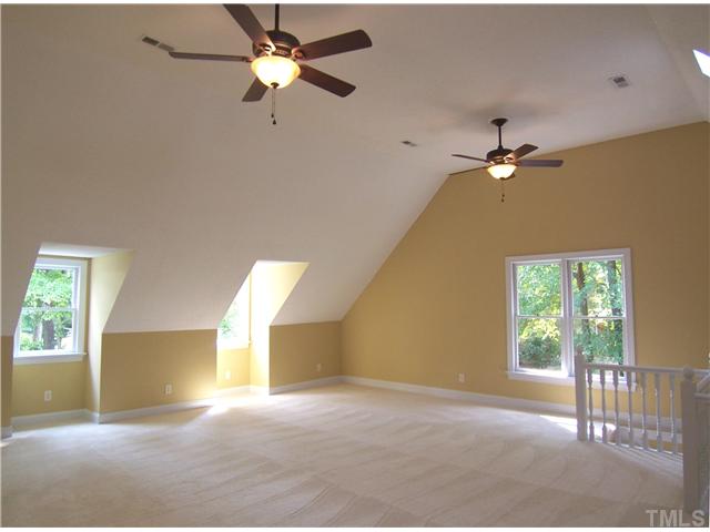 6905 Brook Ridge Court Raleigh, NC 27615 - Photo 14 of 25 Upstairs, the huge vaulted Bonus Rm has skylights, NEW neutral carpet, 2 NEW CFs & BIG WIC offering tons of storage.