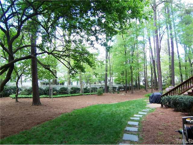 6905 Brook Ridge Court Raleigh, NC 27615 - Photo 24 of 25 Outside, the .53 ac lot is landscaped & wooded and there is an attached StorageRm!