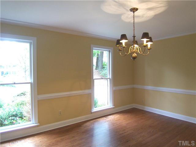 6905 Brook Ridge Court Raleigh, NC 27615 - Photo 5 of 25 Lg formal Dining Rm offers new paint, beautiful hrdwd flr & swinging door to the Kitchen. The NEW oil-rubbed bronze light fixture will be installed soon.