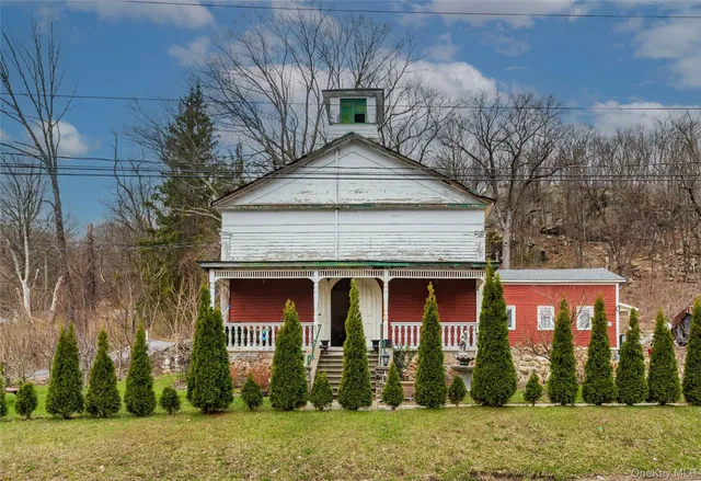 a view of a brick house with large windows