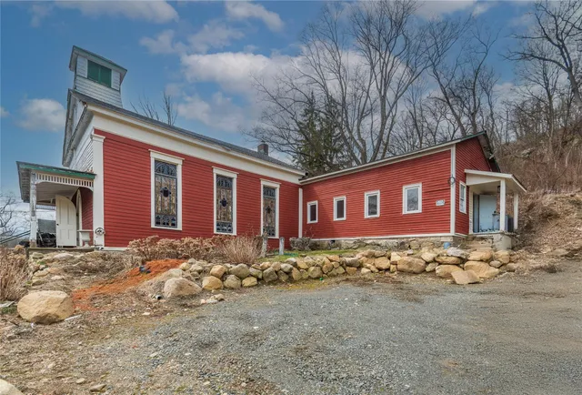 a view of a house with a yard covered in snow