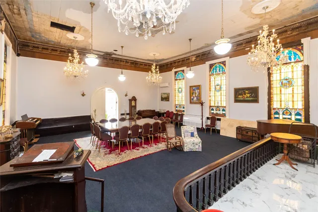 a living room with lots of furniture and a chandelier