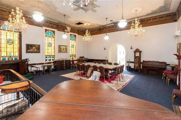 a living room with lots of furniture and a large window