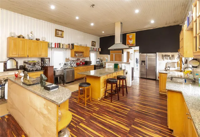 a view of a kitchen with dining room and wooden floor