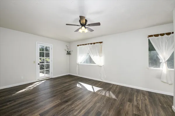 a view of empty room with wooden floor