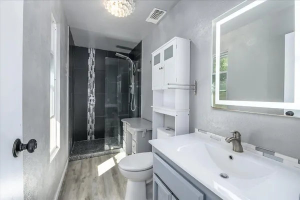 a view of wooden floor and windows in a room