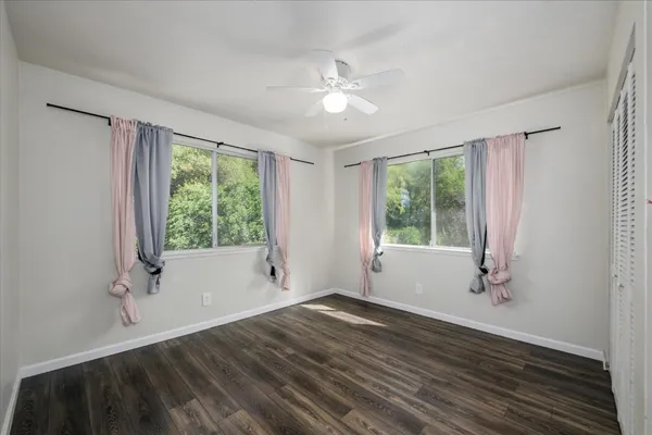 a bathroom with a granite countertop toilet and a sink