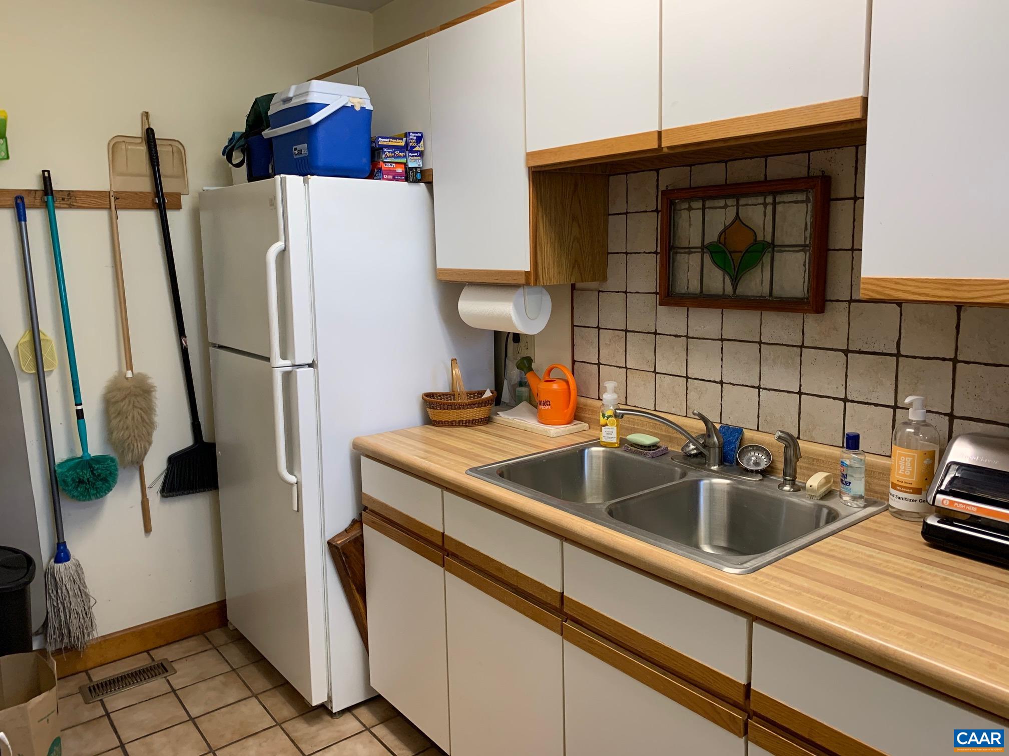 2765 Seville Road Madison, VA 22727 - Photo 11 of 50 a kitchen with refrigerator a sink a stove and cabinets