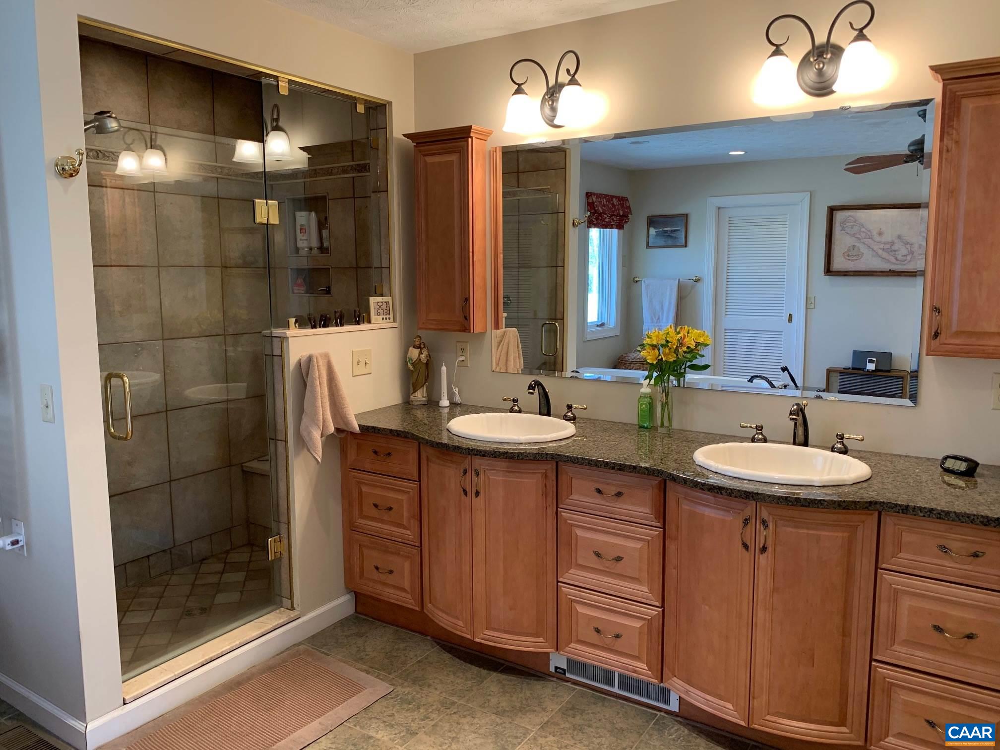 2765 Seville Road Madison, VA 22727 - Photo 17 of 50 a bathroom with a sink double vanity and a shower