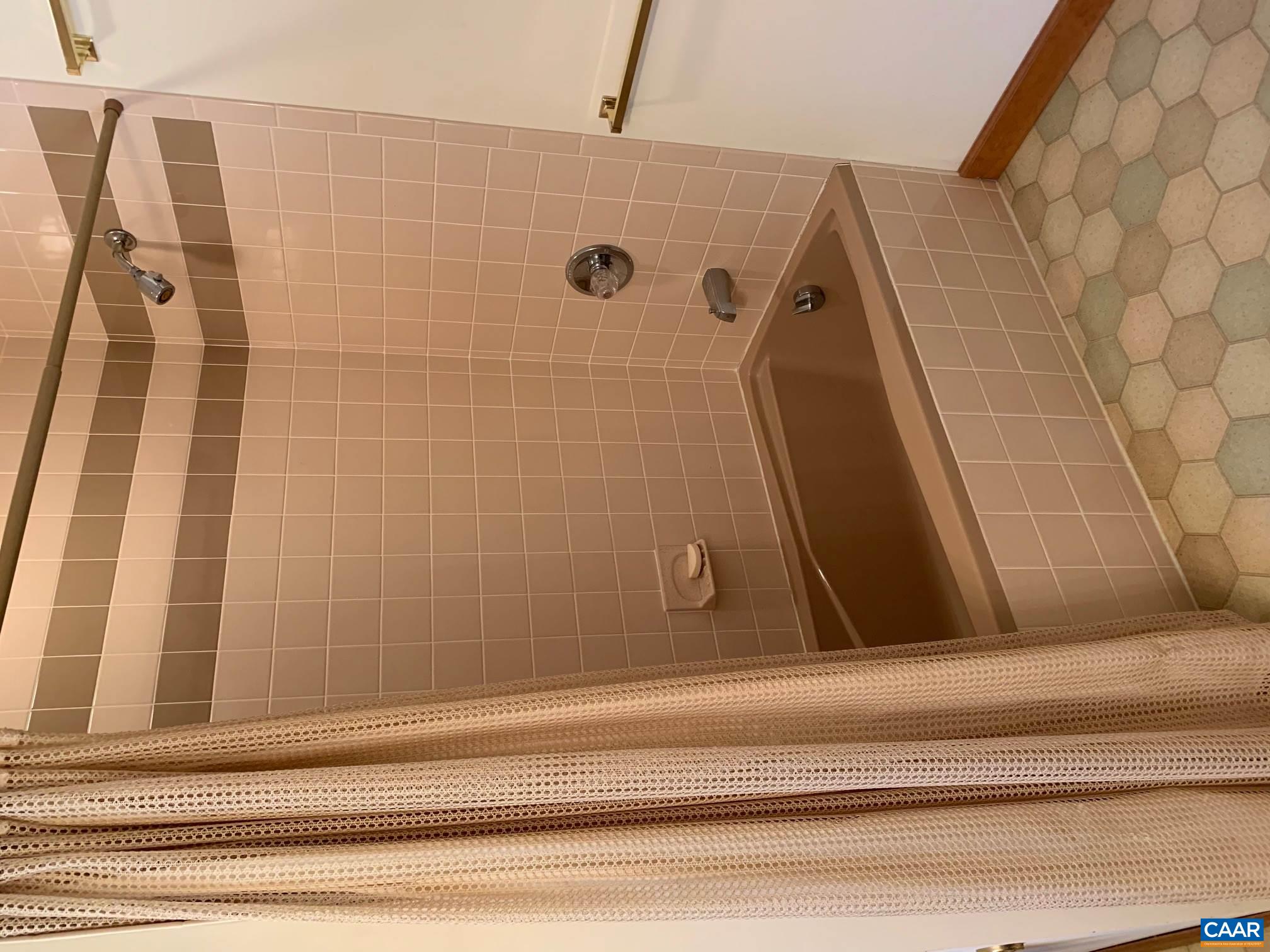 2765 Seville Road Madison, VA 22727 - Photo 27 of 50 a bathroom with a tub a sink and a shower