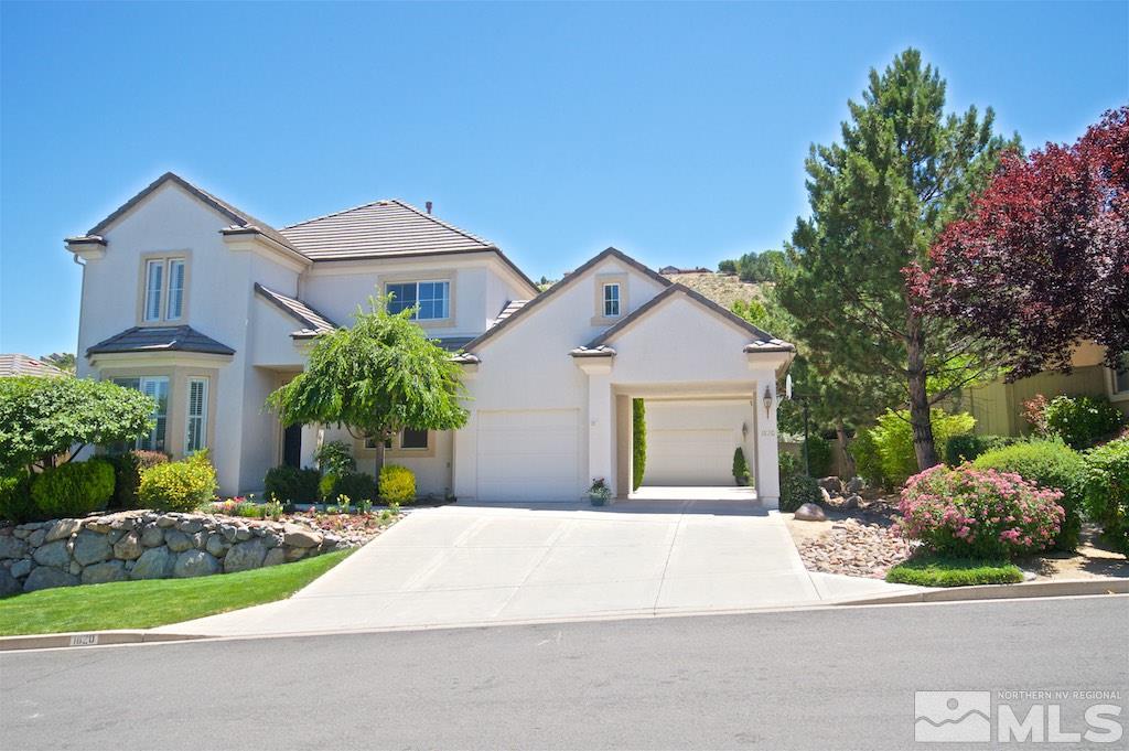 a front view of a house with a yard and garage