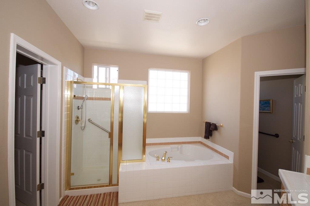 1820 Hunter Creek Road Reno, NV 89519 - Photo 13 of 22 a bathroom with a tub a sink and a large mirror