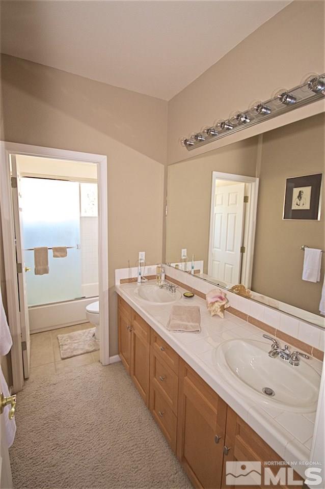 1820 Hunter Creek Road Reno, NV 89519 - Photo 20 of 22 a bathroom with a double vanity sink mirror and bathtub