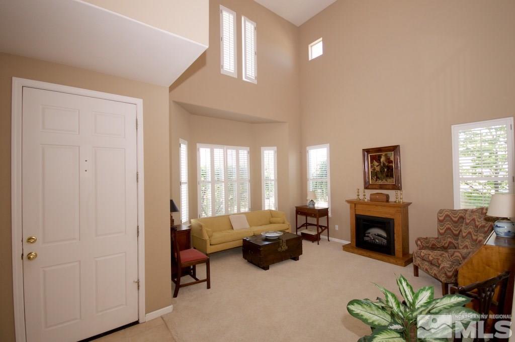 1820 Hunter Creek Road Reno, NV 89519 - Photo 3 of 22 a living room with furniture large window and a fireplace