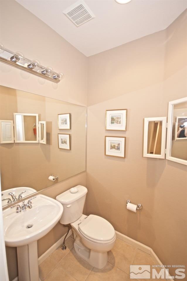 1820 Hunter Creek Road Reno, NV 89519 - Photo 8 of 22 a bathroom with a white toilet sitting next to a bathroom sink