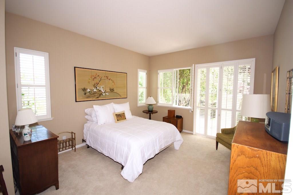 1820 Hunter Creek Road Reno, NV 89519 - Photo 10 of 22 a bedroom with a bed and a couch next to a window