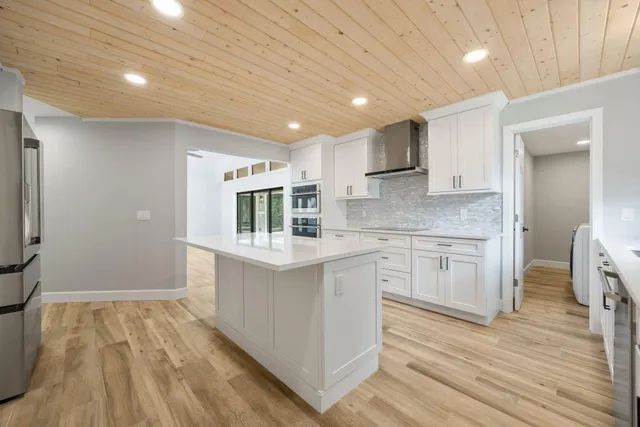 a kitchen with cabinets and wooden floor