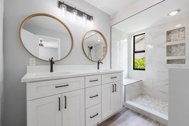 a bathroom with a double vanity sink and a mirror