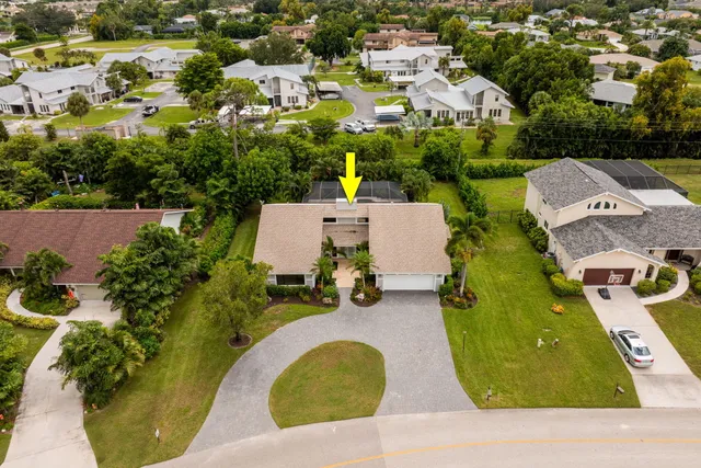 an aerial view of a house with a swimming pool