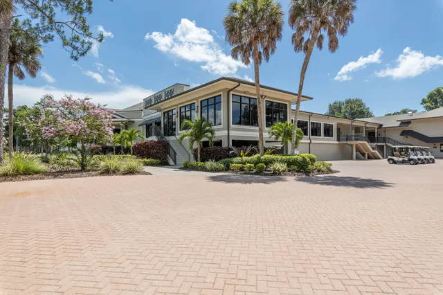 an aerial view of a house with a yard and lake view