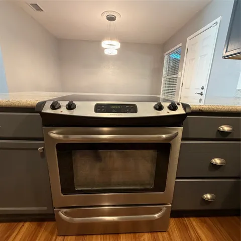 a stove top oven sitting inside of a kitchen