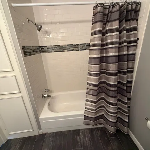 a bathroom with a shower and a sink
