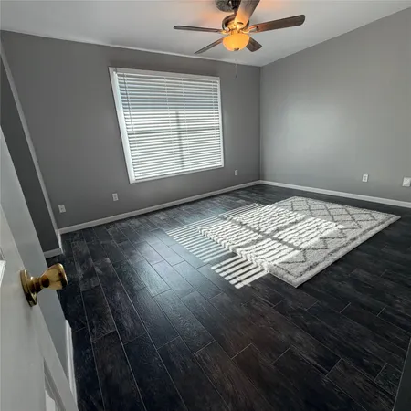 wooden floor and window in an empty room