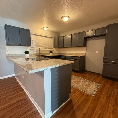 a kitchen with a sink stove and cabinets