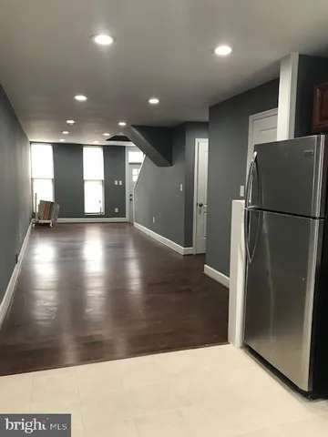 a view of a refrigerator in wooden floor