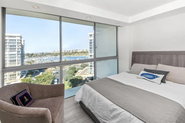 a bedroom with a bed couch and window