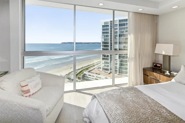 a bedroom with a bed and a large window